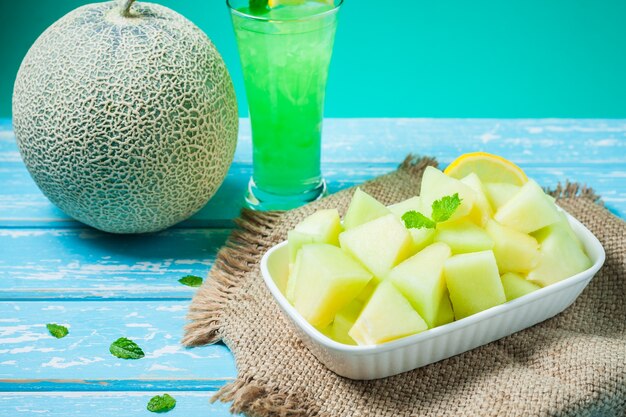 Fresh Honeydew melon on wooden table, healthy food.