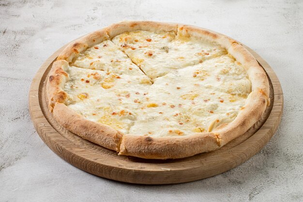 Fresh hot cheese pizza on the concrete background