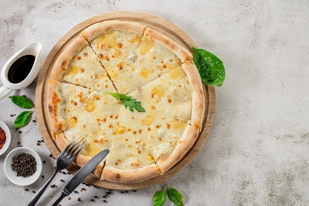 Fresh hot cheese pizza on the concrete background