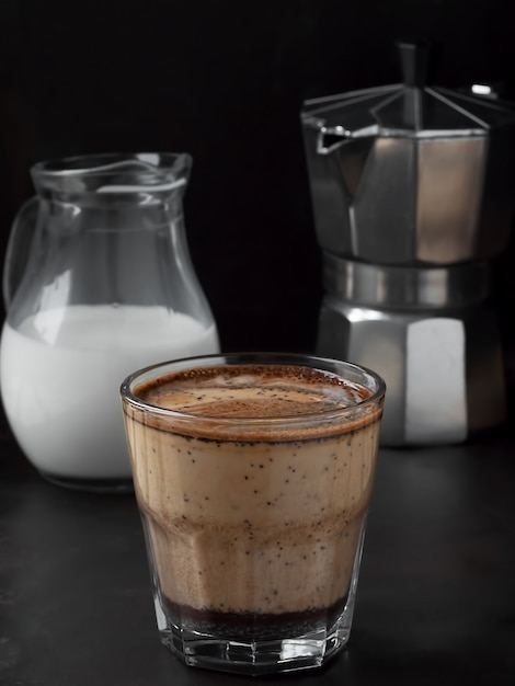 Fresh hot coffee in a glass with cream