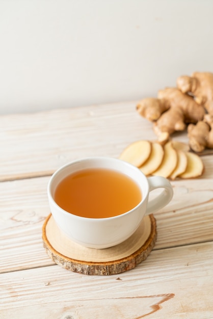 fresh and hot ginger juice glass with ginger roots - Healthy drink style