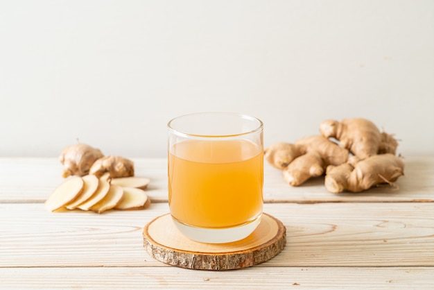 fresh and hot ginger juice glass with ginger roots - Healthy drink style