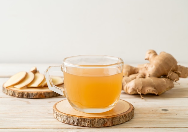 fresh and hot ginger juice glass with ginger roots - Healthy drink style