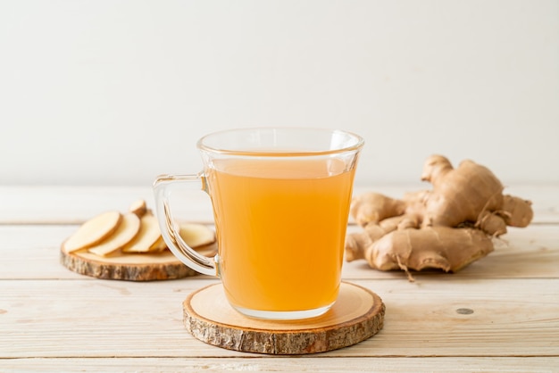 Fresh and hot ginger juice glass with ginger roots - Healthy drink style