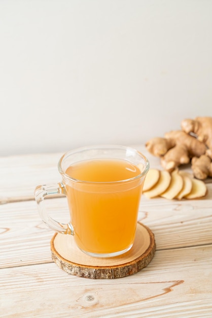 fresh and hot ginger juice glass with ginger roots - Healthy drink style