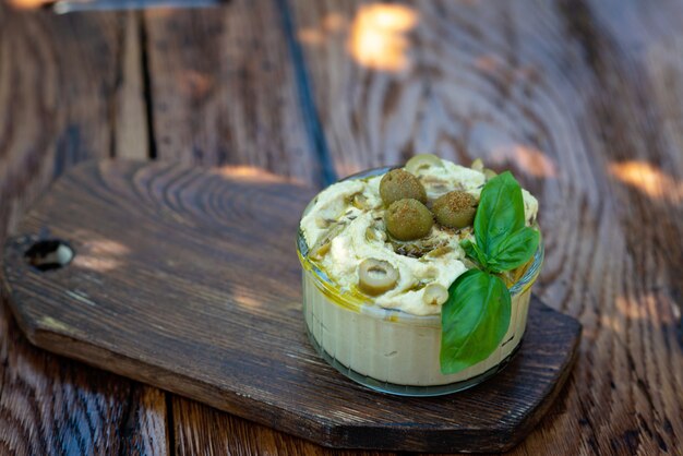 Fresh hummus in a bowl on the table