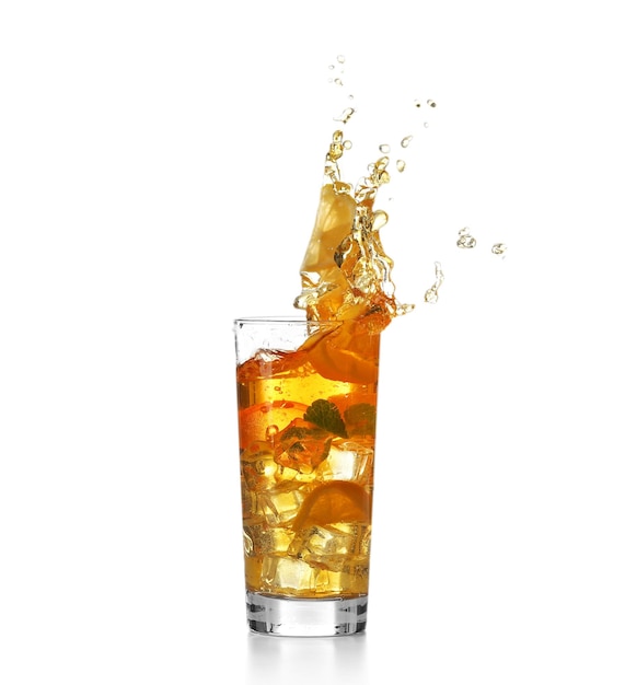 Fresh iced tea splashing in glass