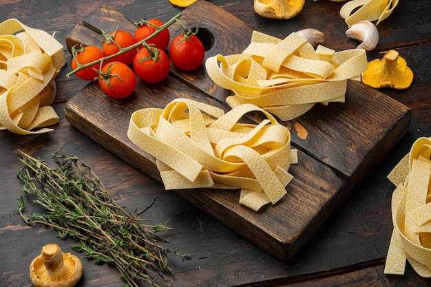Fresh ingredients for cooking pasta set, on old dark  wooden table background