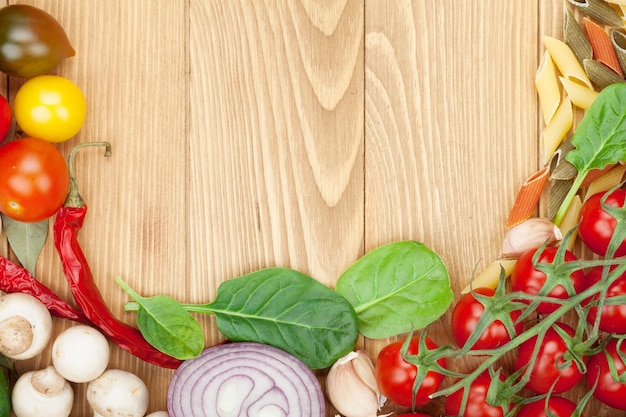 Fresh ingredients for cooking pasta tomato cucumber mushroom and spices