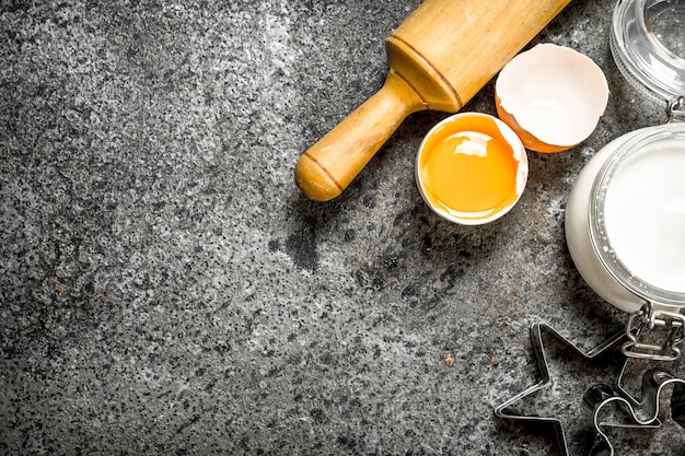 Fresh ingredients for dough on rustic table.