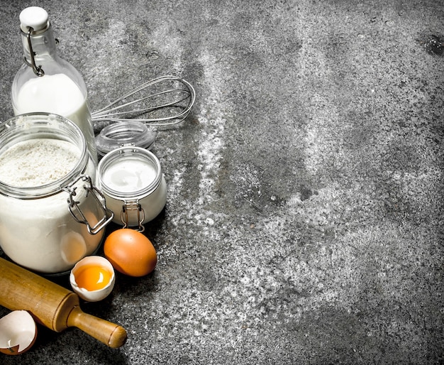 Fresh ingredients for dough on rustic table.