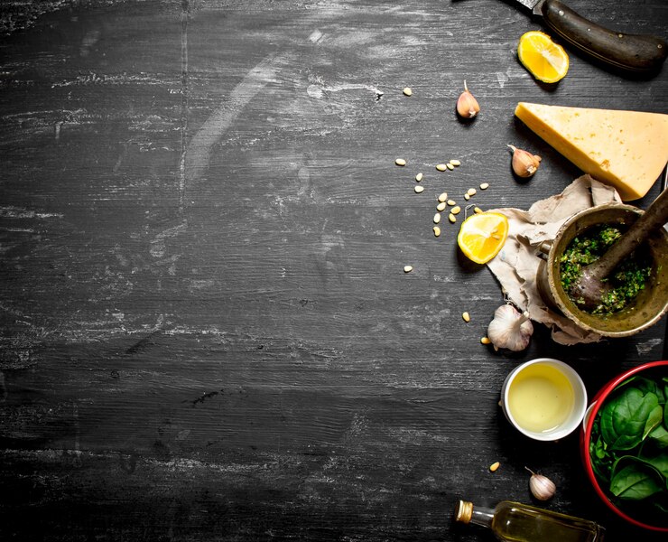 Photo fresh ingredients for italian pesto on the black wooden table.