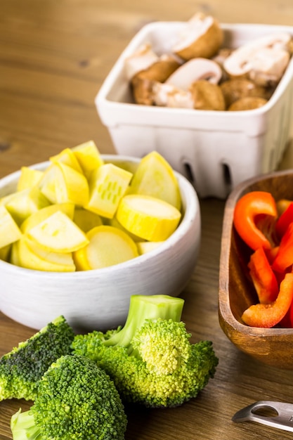 Fresh ingredients for preparing roasted mixed vegetables on the table.