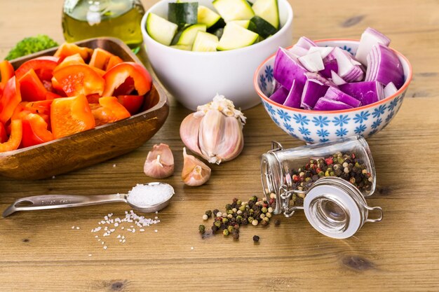 Fresh ingredients for preparing roasted mixed vegetables on the table.