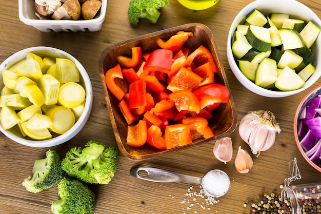 Fresh ingredients for preparing roasted mixed vegetables on the table.