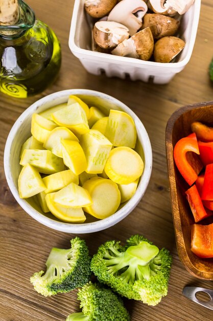 Fresh ingredients for preparing roasted mixed vegetables on the table.