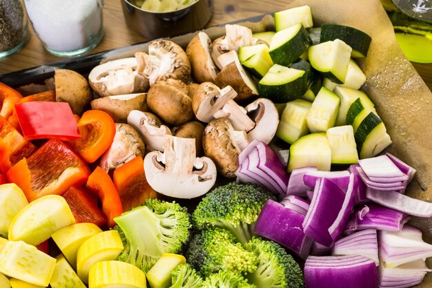 Fresh ingredients for preparing roasted mixed vegetables on the table