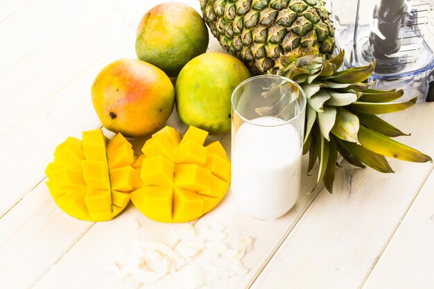 Fresh ingredients on the table to make smoothie with tropical fruits.