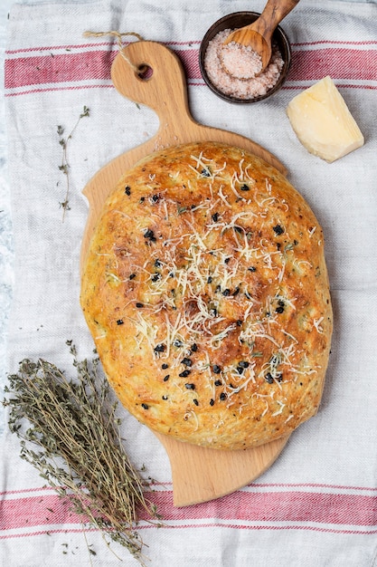 Fresh italian focaccia bread with herbs and olives