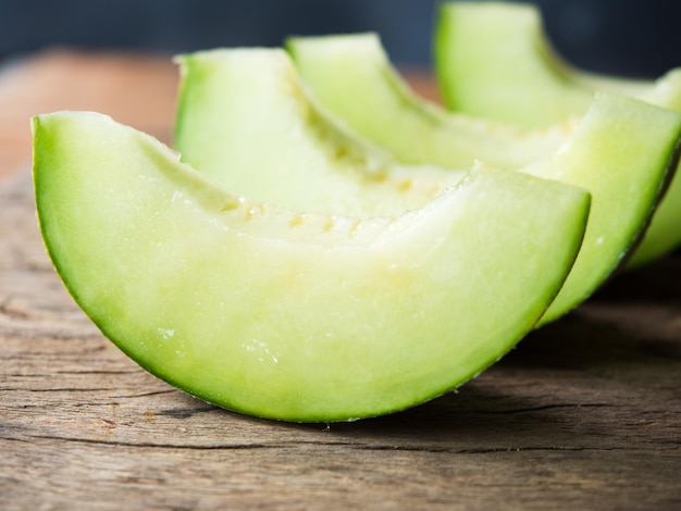 fresh japanese green melon fruit or honeydew on rustic wooden table