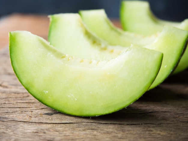 Fresh Japanese green melon fruit or honeydew on rustic wooden table