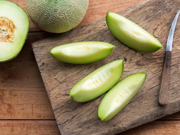 Fresh Japanese green melon fruit or honeydew on rustic wooden table