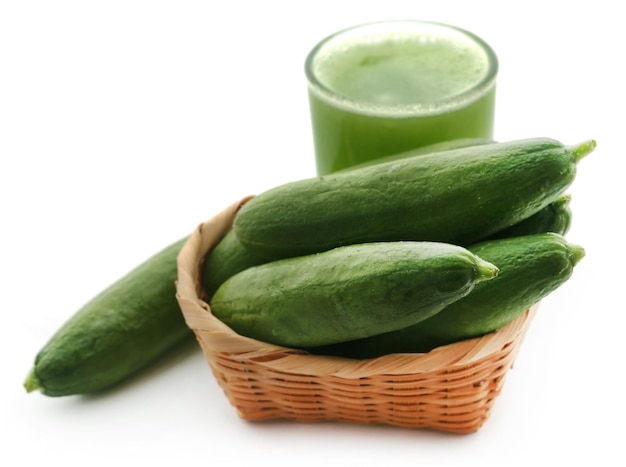 Fresh juice of green cucumber in a glass over white background