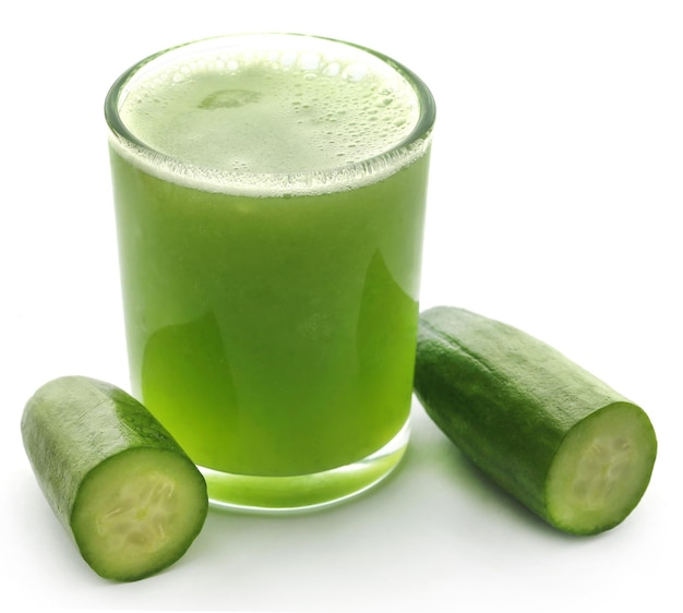 Fresh juice of green cucumber over white background