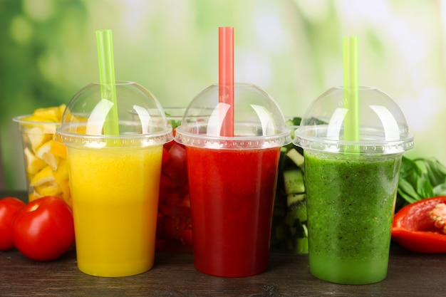 Fresh juice mix fruit healthy drinks on wooden table on bright background