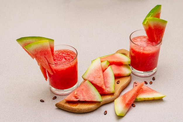 Fresh juice of watermelon, smoothie, cocktail. Sweet summer dessert, slices on wooden cutting board