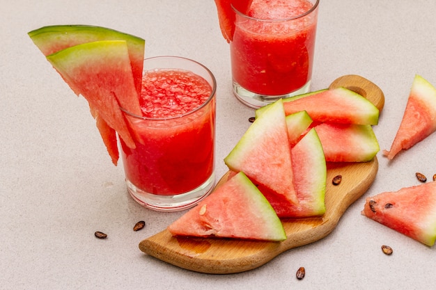 Fresh juice of watermelon, smoothie, cocktail. Sweet summer dessert, slices on wooden cutting board