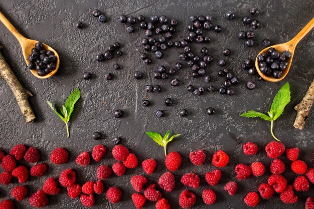 Fresh juicy berries on dark concrete background