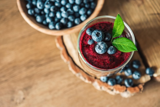 Fresh juicy blueberry smoothies in the glass Simple background Healthy food Detox Lifestyle