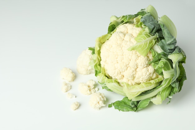 Fresh juicy cauliflower with slices on white background