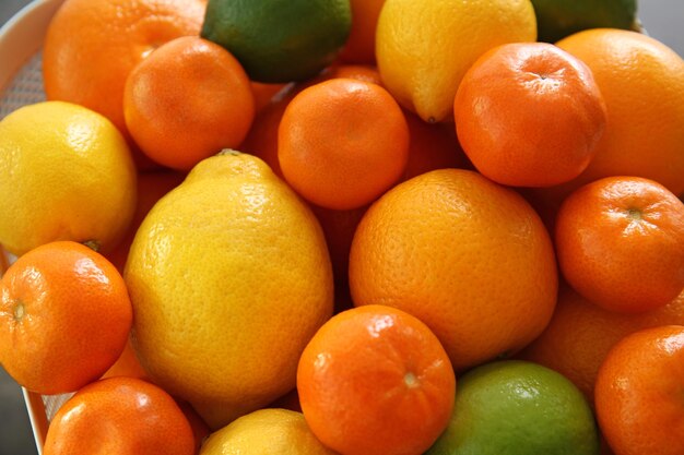 Fresh juicy citrus fruits in basket closeup