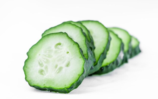 Fresh juicy cucumber slices on a white background