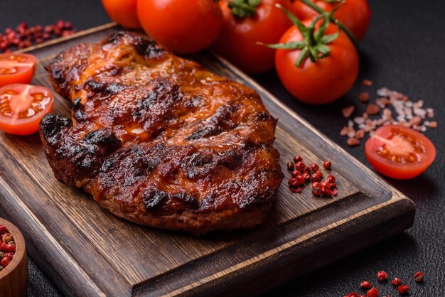 Fresh juicy delicious beef steak on a dark background