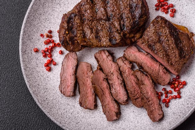 Fresh juicy delicious beef steak on a dark background