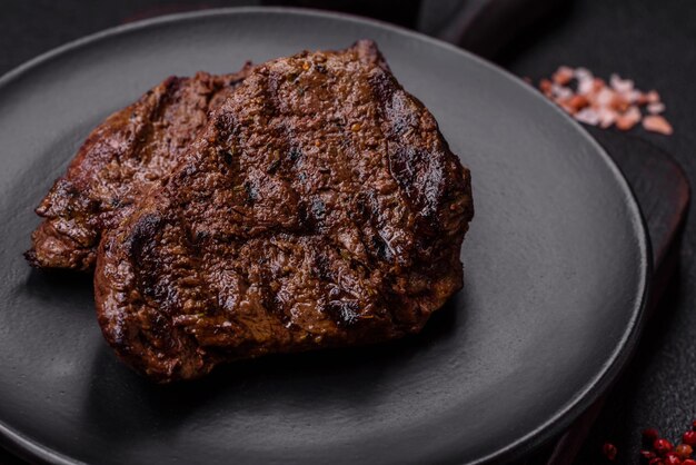 Fresh juicy delicious beef steak on a dark background