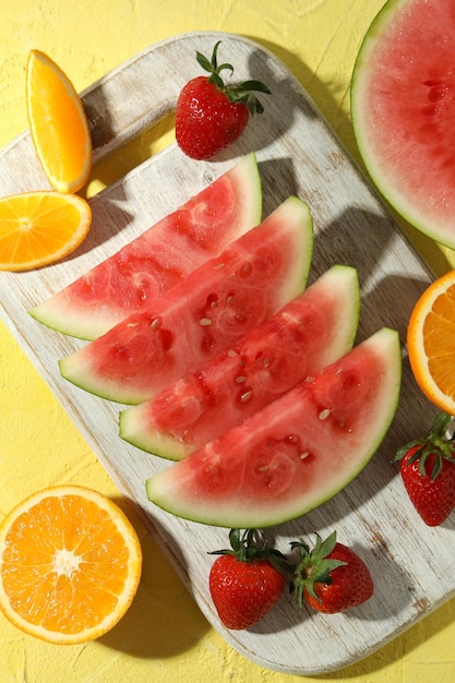 Fresh and juicy fruits on yellow textured background