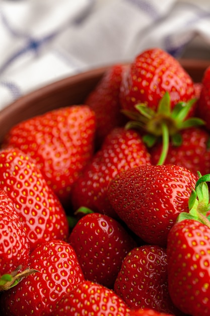 Fresh juicy large strawberry in a bowl. Close up.