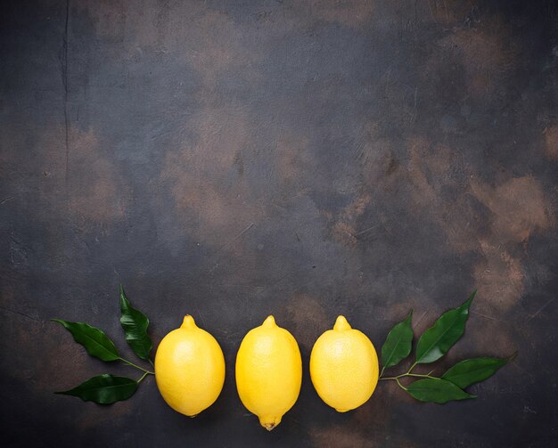 Fresh juicy lemons on rusty background