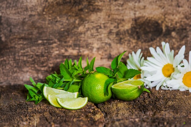 Fresh juicy limes on wooden table. Mojito