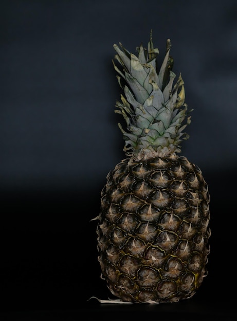 fresh juicy pineapple on black background