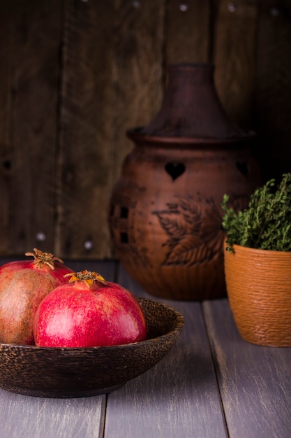 Fresh juicy pomegranate on a dark wooden background