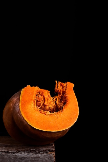 Fresh juicy pumpkin slice on black