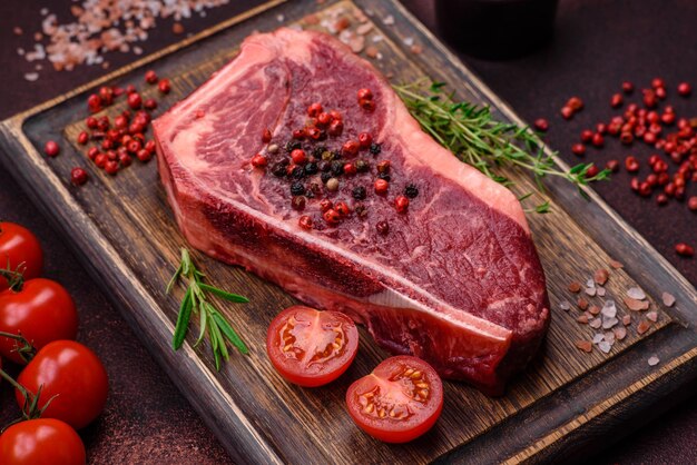 Fresh juicy raw new york beef steak with salt spices and herbs