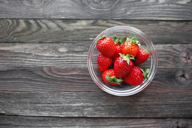 Fresh juicy strawberries in glass bowl. 