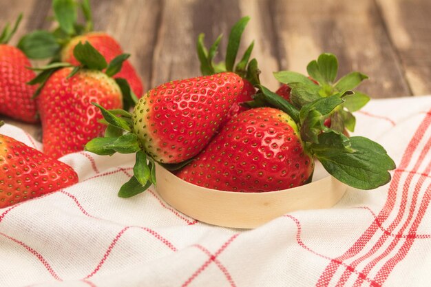 Fresh juicy strawberries on a wooden background