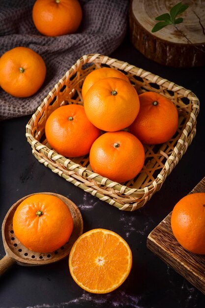 Fresh juicy tangerine orange slice in the wooden basket closeup view